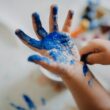 person with blue paint on hand