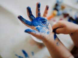 person with blue paint on hand