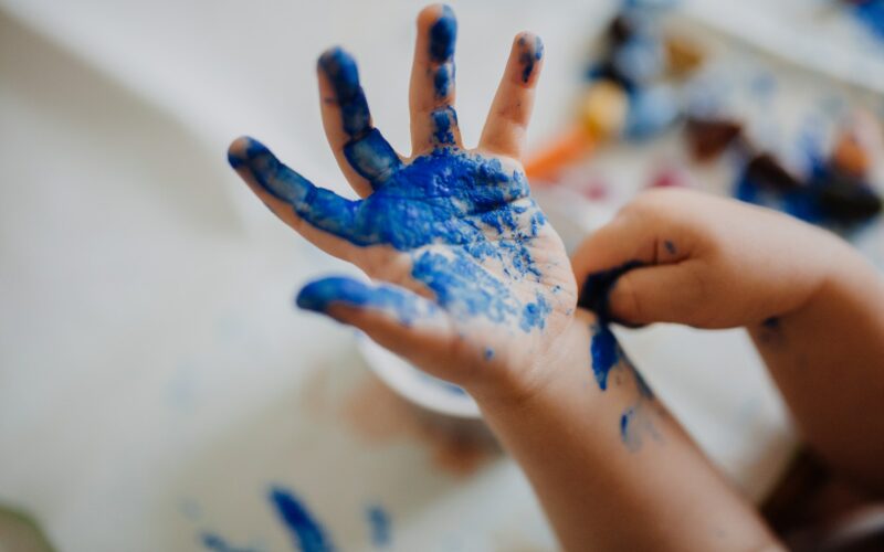 person with blue paint on hand