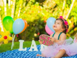 toddler looking up while holding candycane in party